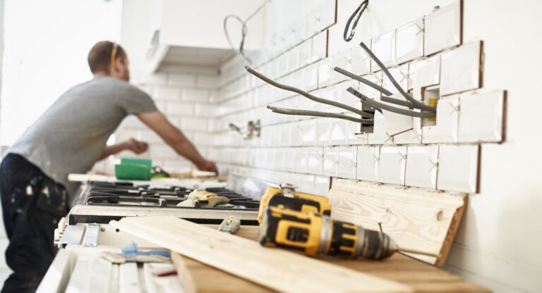 a-man-working-in-a-new-kitchen-a-tiler-applying-t-2026-01-09-10-06-07-utc